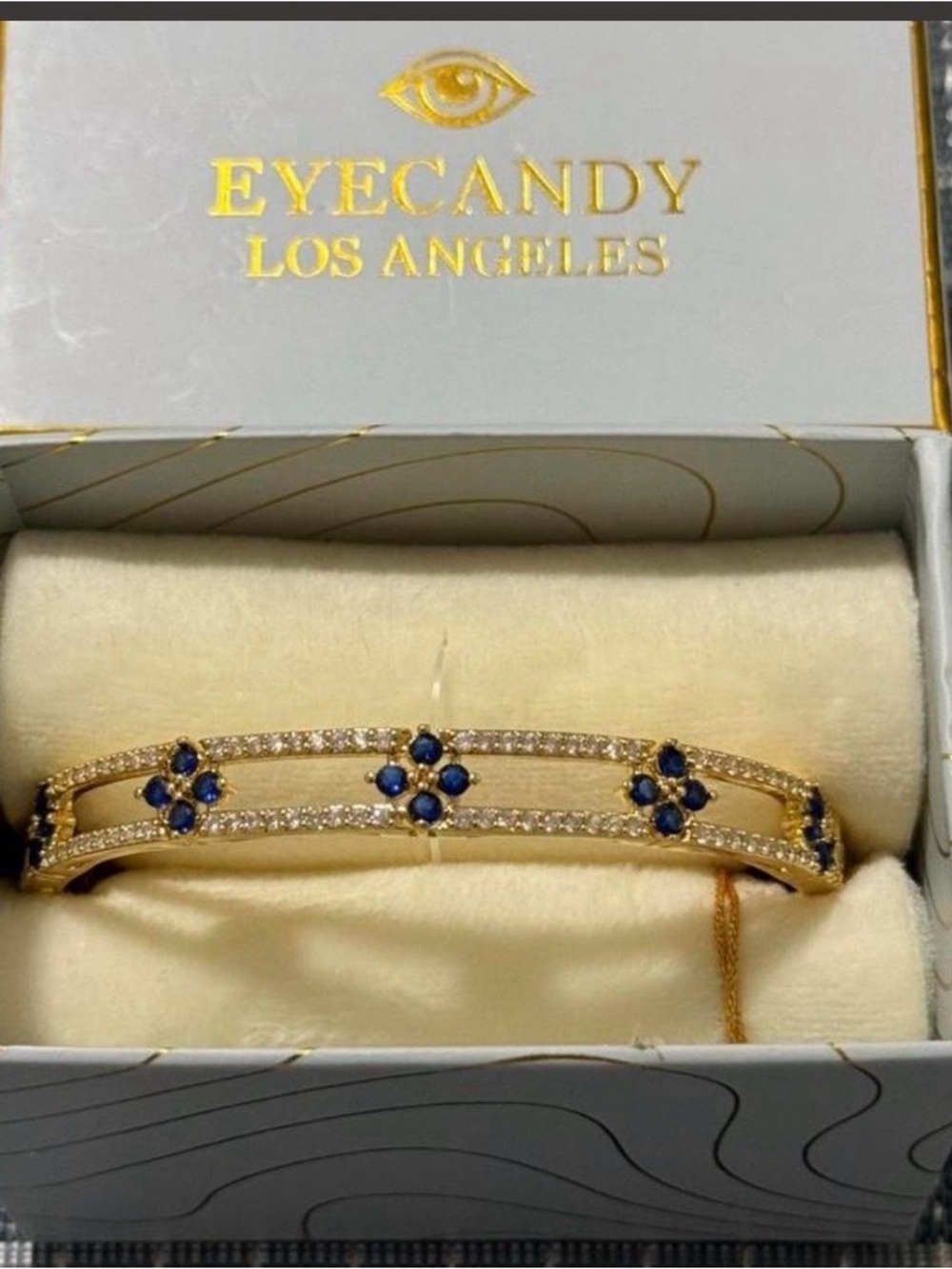 Eye Candy Gold Brass, Cubic Zirconia, Blue Stone Hinged Bangle